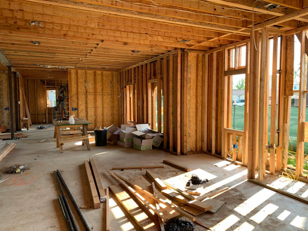 pexels-photo-4642438-4642438 Sunlit interior with wood framing, showcasing home construction progress.