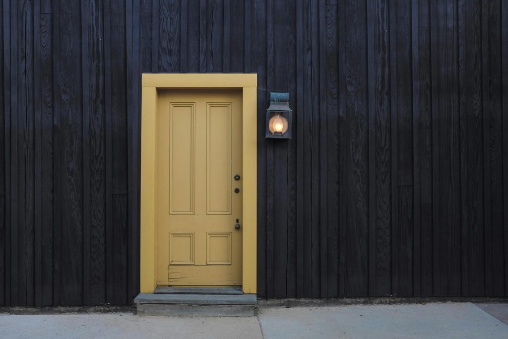pexels-photo-277559-277559 A modern yellow door on a dark wooden facade creates a striking contrast. Architectural detail.