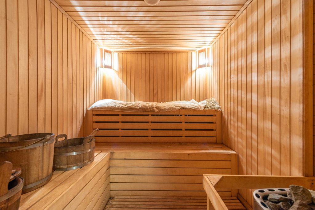 pexels-photo-8092430-8092430 Warm and inviting wooden sauna with ambient lighting, perfect for relaxation.